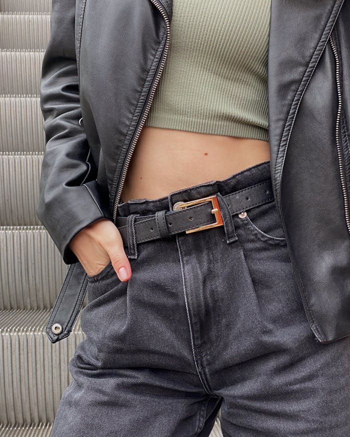 about-us Trendy urban fashion featuring a black leather jacket, crop top, and denim pants, ideal for edgy style inspiration.